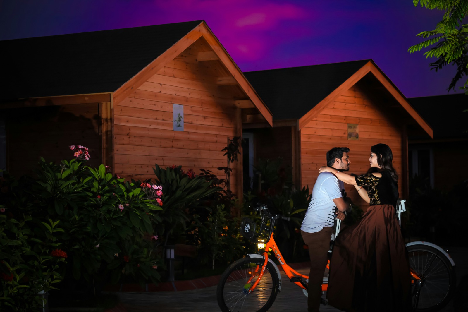 Couple by a cottage under a violet sky