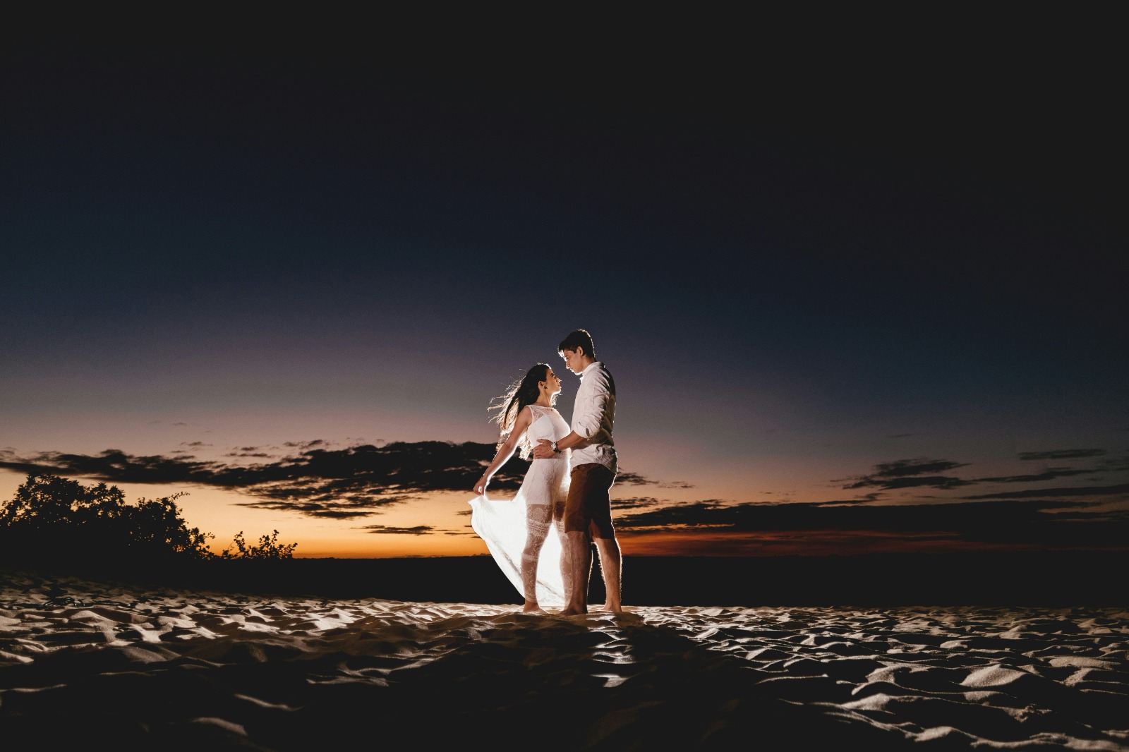 Couple on the dunes at twilight